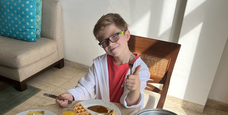 Kid enjoying room service at the Grand Fiesta Americana Coral Beach in Cancun, Mexico.