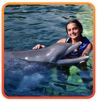 Young girls swimming with the dolphins in Cancun, Mexico